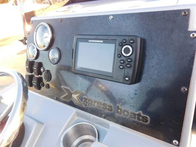 Slide: The Image of Dashboard of 2021 Xpress Boats H190 with gauges and Humminbird display. - 10