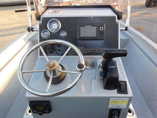 Slide: The Image of 2021 Xpress Boats H190 console with steering wheel, gauges, and controls. - 8