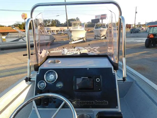 Slide: The Image of 2021 Xpress Boats H190 dashboard with steering wheel and navigation controls. - 9