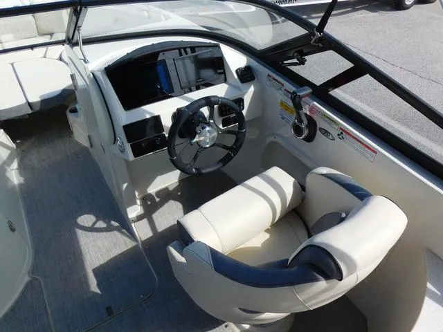 Slide: The Image of 2024 Stingray 231DC boat cockpit with modern steering and controls. - 10