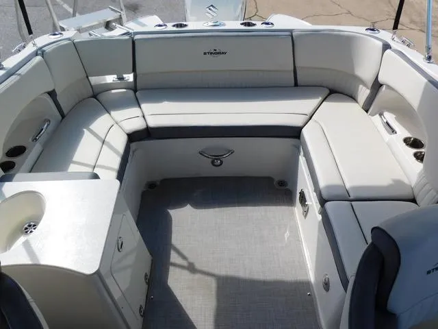 Slide: The Image of 2024 Stingray 231DC boat interior with spacious seating and modern design. - 12