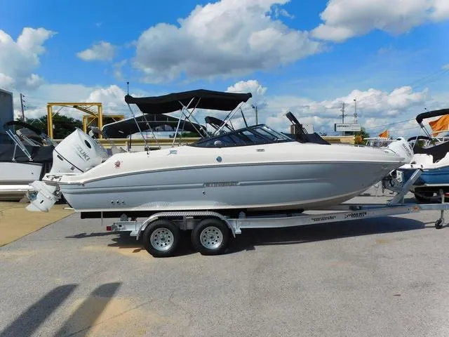Slide: The Image of 2024 Stingray 231DC boat on trailer under blue sky with clouds. - 16