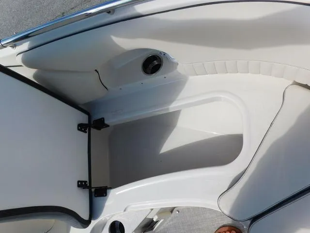Slide: The Image of 2024 Stingray 231DC boat interior storage compartment with open hatch. - 8