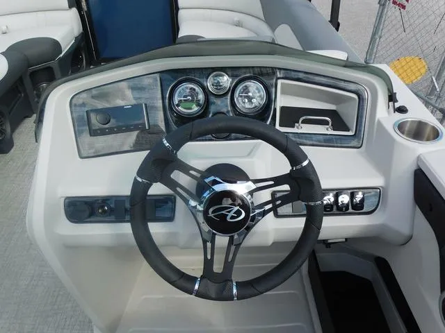 Slide: The Image of 2024 Avalon 2585 LSZ Quad Lounger dashboard with steering wheel and control panel. - 17