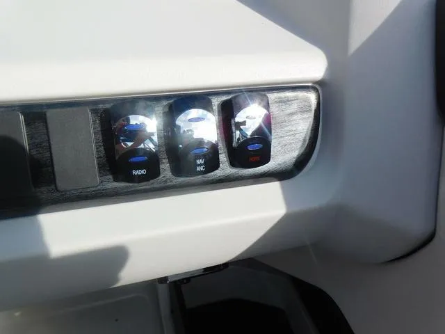 Slide: The Image of Control panel of 2024 Avalon 2585 LSZ Quad Lounger with radio, navigation, and horn switches. - 21