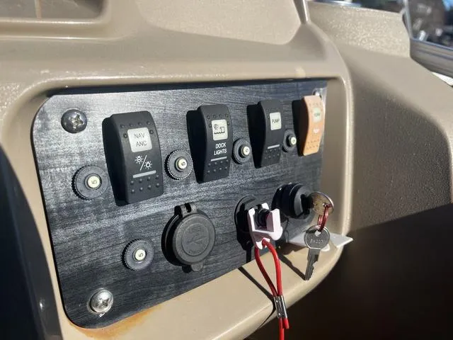 Slide: The Image of Control panel of a 2020 Starcraft LX 22 R boat with switches and ignition keys. - 10