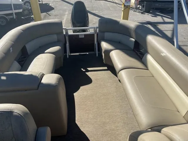Slide: The Image of 2020 Starcraft LX 22 R pontoon boat interior with beige seating and spacious layout. - 12