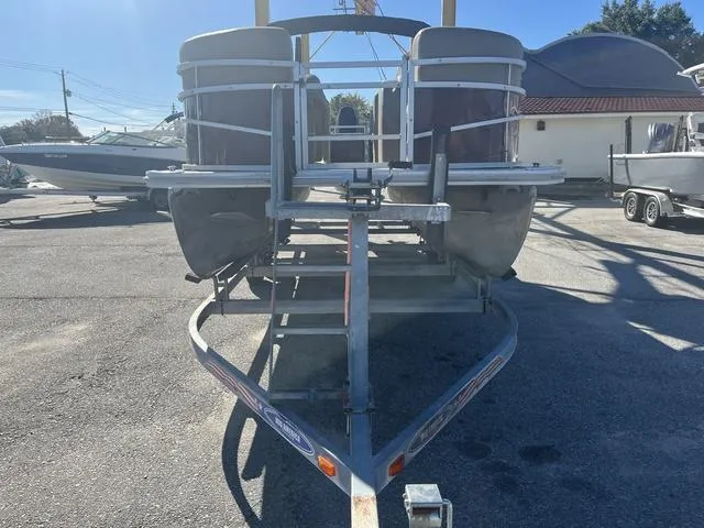 Slide: The Image of 2020 Starcraft LX 22 R pontoon boat on trailer in outdoor setting. - 3