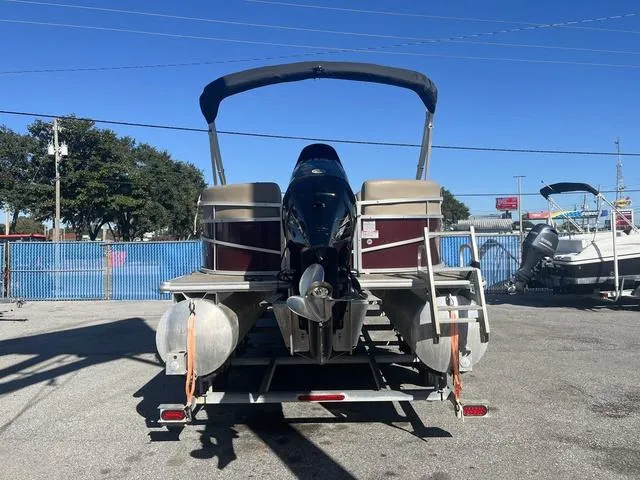 Slide: The Image of 2020 Starcraft LX 22 R pontoon boat on trailer, rear view, sunny day. - 4