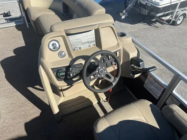 Slide: The Image of 2020 Starcraft LX 22 R boat dashboard with steering wheel and controls. - 7