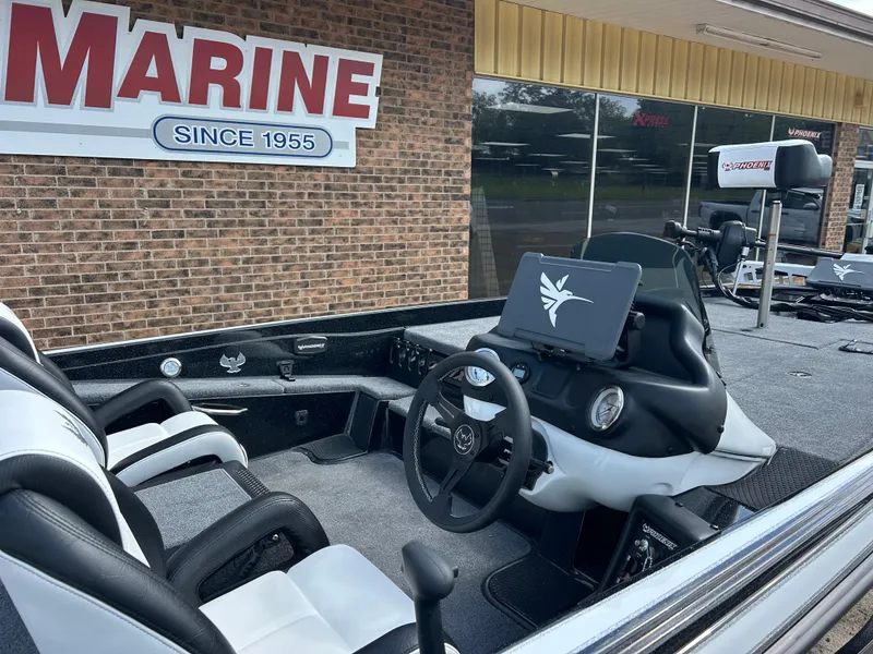 Slide: The Image of 2025 Phoenix 721 ZXL boat interior at marine dealership, featuring modern dashboard and seating. - 4