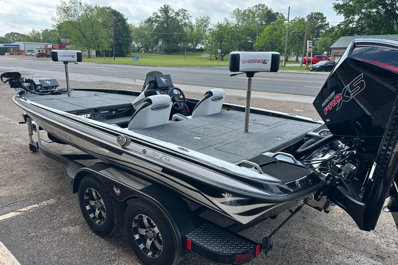 Slide: The Image of 2025 Phoenix 721 ZXL boat with dual seats and powerful engine, parked outdoors. - 8