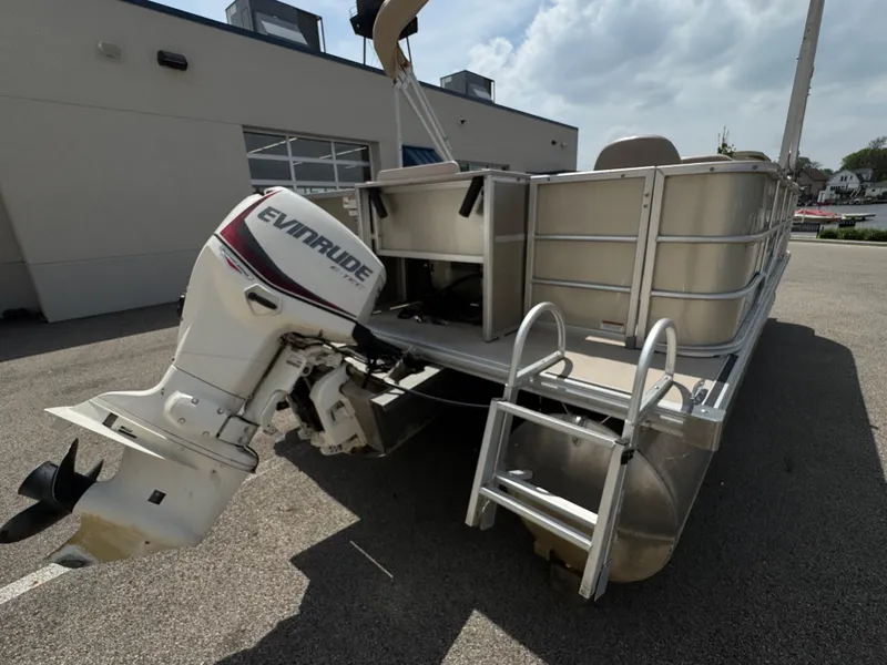 Slide: The Image of 2014 Sylvan Mirage Fish 8520 CNF pontoon boat with Evinrude outboard motor, parked outdoors. - 10