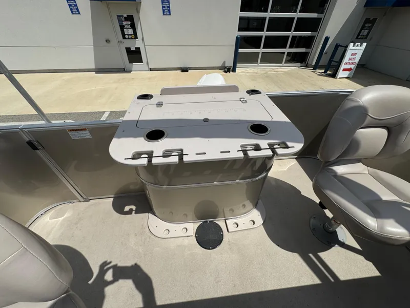Slide: The Image of 2014 Sylvan Mirage Fish 8520 CNF boat interior with seating and table setup. - 12