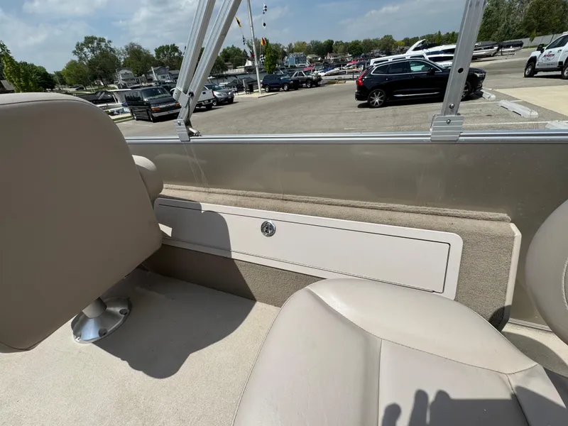 Slide: The Image of 2014 Sylvan Mirage Fish 8520 CNF boat interior with beige seating and storage compartment. - 14
