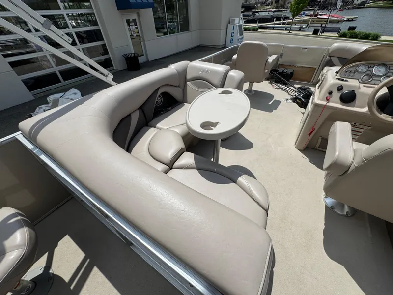 Slide: The Image of 2014 Sylvan Mirage Fish 8520 CNF boat interior with beige seating and round table. - 15