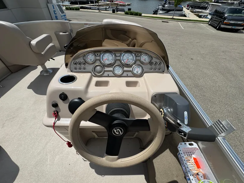 Slide: The Image of 2014 Sylvan Mirage Fish 8520 CNF boat dashboard with steering wheel and gauges. - 17