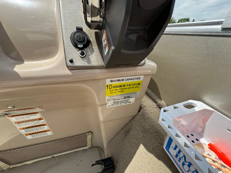 Slide: The Image of 2014 Sylvan Mirage Fish 8520 CNF boat interior with capacity label and storage box. - 18