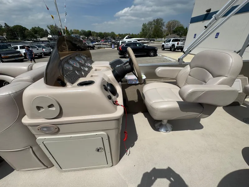 Slide: The Image of 2014 Sylvan Mirage Fish 8520 CNF boat interior with steering console and captain's chair. - 19