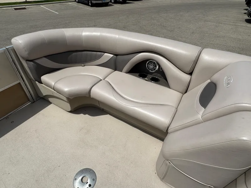 Slide: The Image of 2014 Sylvan Mirage Fish 8520 CNF boat interior with beige seating and cup holders. - 20