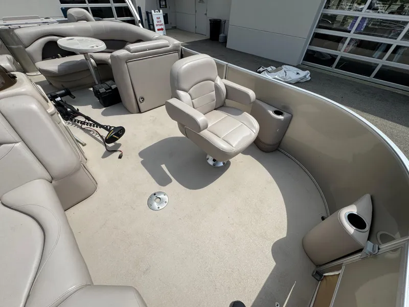 Slide: The Image of 2014 Sylvan Mirage Fish 8520 CNF boat interior with beige seating and fishing equipment. - 22