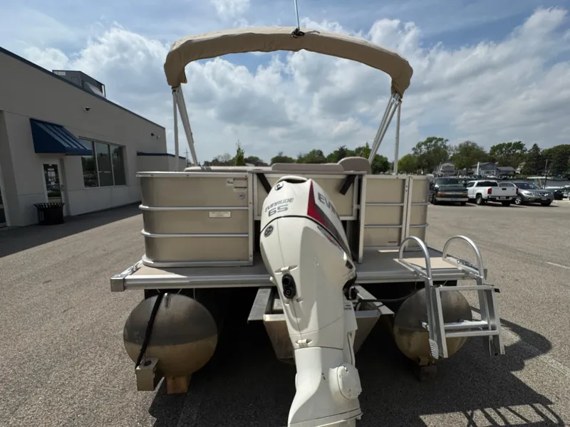 Slide: The Image of 2014 Sylvan Mirage Fish 8520 CNF pontoon boat with outboard motor, parked outdoors. - 8