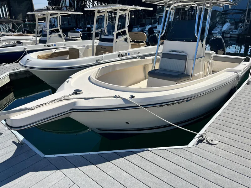 Slide: The Image of 2022 Defiance Commander boat docked at marina, featuring sleek design and spacious seating. - 12