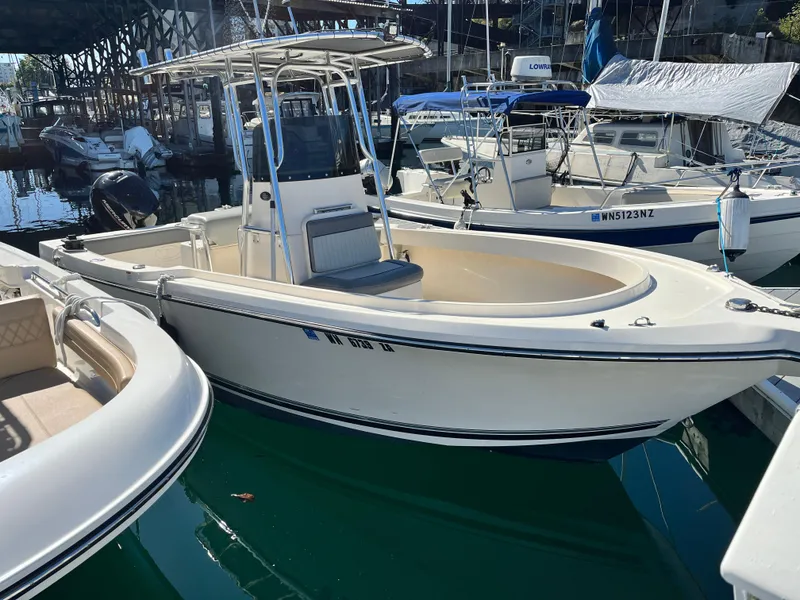 Slide: The Image of 2022 Defiance Commander boat docked in a marina, surrounded by other vessels. - 13