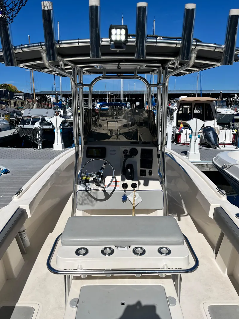 Slide: The Image of 2022 Defiance Commander boat interior with steering console at marina. - 14