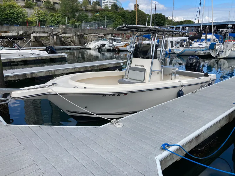 Slide: The Image of 2022 Defiance Commander boat docked at a marina with other vessels. - 15