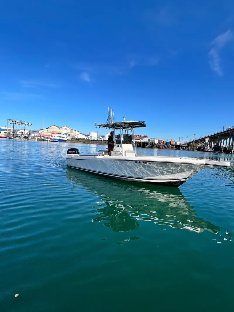 Slide: The Image of 2022 Defiance Commander boat on calm water under clear blue sky. - 20