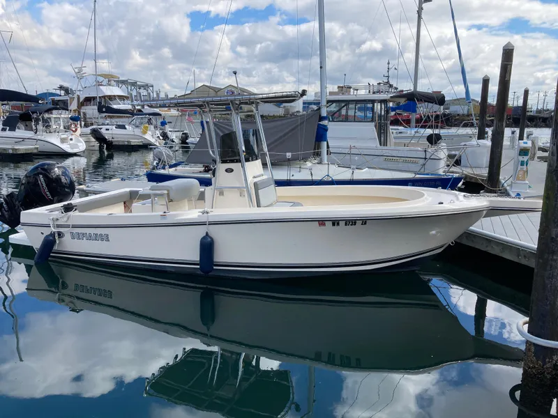 Slide: The Image of 2022 Defiance Commander boat docked at a marina, surrounded by other vessels. - 3