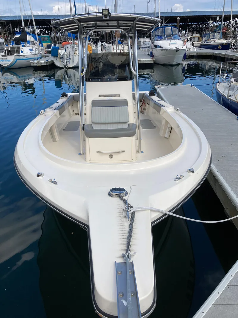 Slide: The Image of 2022 Defiance Commander boat docked at marina, surrounded by other vessels. - 4