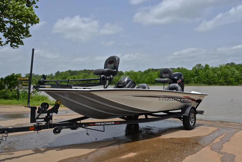 Slide: The Image of 2023 Bass Tracker Pro Team 195 TXE boat on trailer by a lake. - 10