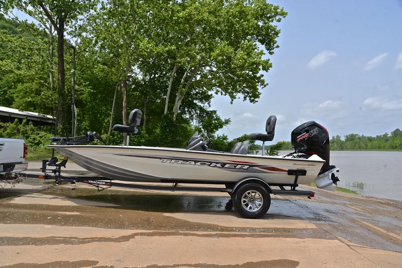 Slide: The Image of 2023 Bass Tracker Pro Team 195 TXE boat on trailer by a lake. - 11