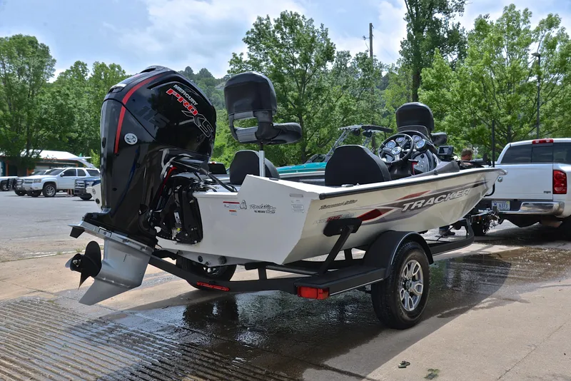 Slide: The Image of 2023 Bass Tracker Pro Team 195 TXE boat on trailer, parked outdoors. - 14