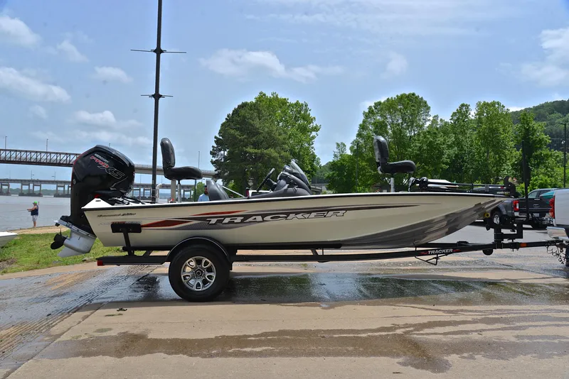 Slide: The Image of 2023 Bass Tracker Pro Team 195 TXE boat on trailer by riverside. - 15
