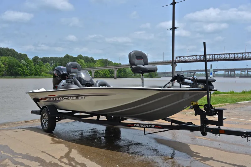 Slide: The Image of 2023 Bass Tracker Pro Team 195 TXE boat on trailer by a river. - 16