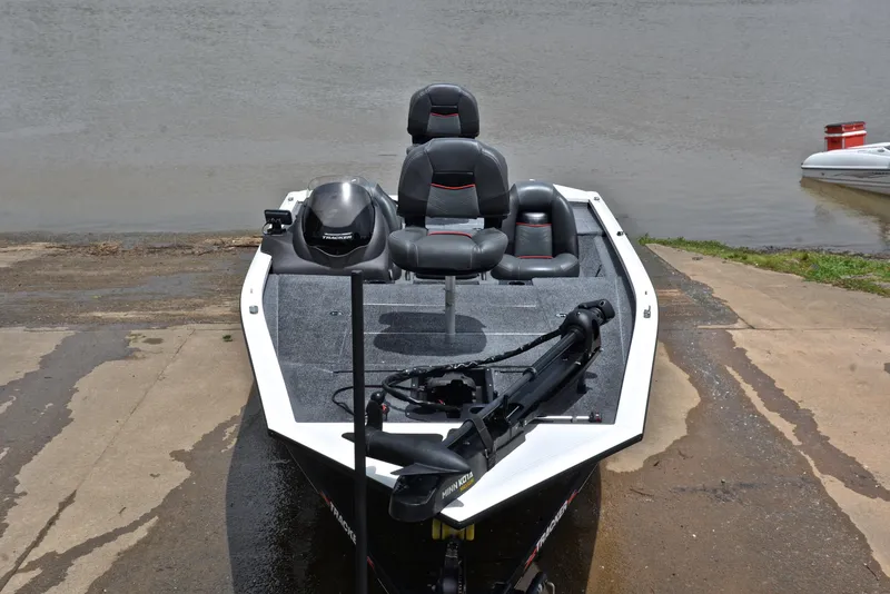 Slide: The Image of 2023 Bass Tracker Pro Team 195 TXE boat at a lakeside launch ramp. - 17