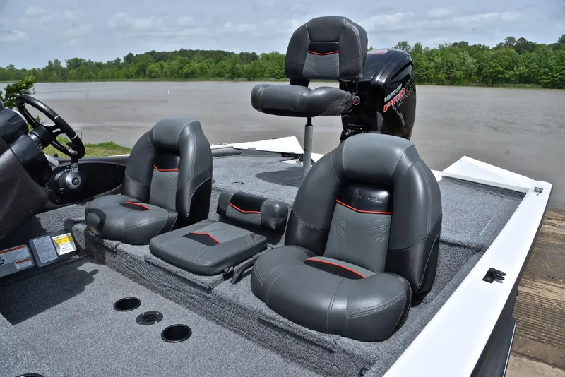 Slide: The Image of 2023 Bass Tracker Pro Team 195 TXE boat with comfortable seating on a lake. - 18