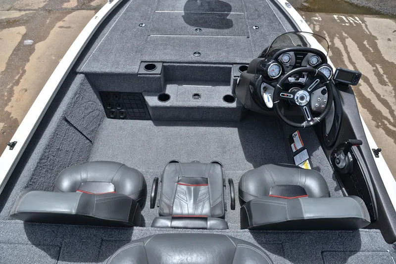 Slide: The Image of 2023 Bass Tracker Pro Team 195 TXE interior with steering console and seating. - 24
