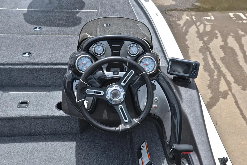 Slide: The Image of 2023 Bass Tracker Pro Team 195 TXE dashboard with steering wheel and gauges. - 25