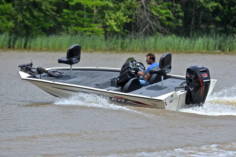 Slide: The Image of 2023 Bass Tracker Pro Team 195 TXE boat cruising on a lake. - 6