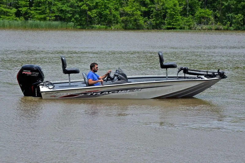 Slide: The Image of 2023 Bass Tracker Pro Team 195 TXE boat cruising on a calm lake. - 7