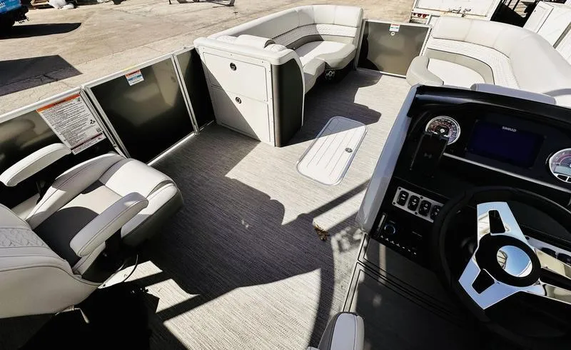 Slide: The Image of 2025 Godfrey Monaco Sundeck 235 SD interior with plush seating and modern dashboard. - 10