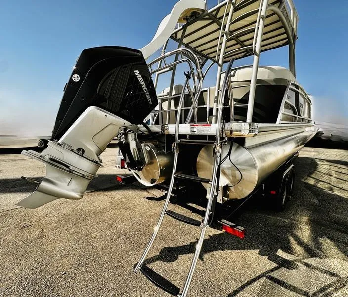 Slide: The Image of 2025 Godfrey Monaco Sundeck 235 SD boat with Mercury outboard engine and ladder. - 15