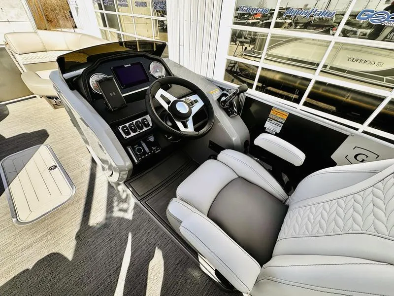 Slide: The Image of 2025 Godfrey Monaco Sundeck 235 SD boat interior with modern helm and luxurious seating. - 17