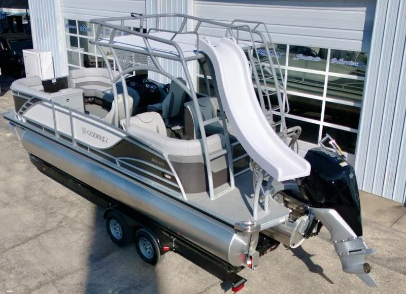 Slide: The Image of 2025 Godfrey Monaco Sundeck 235 SD pontoon boat with slide, parked on trailer. - 3