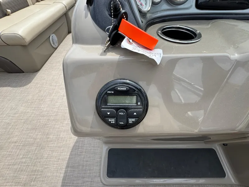 Slide: The Image of Control panel of a 2021 Sun Tracker Party Barge 20 DLX with keys and stereo system. - 11