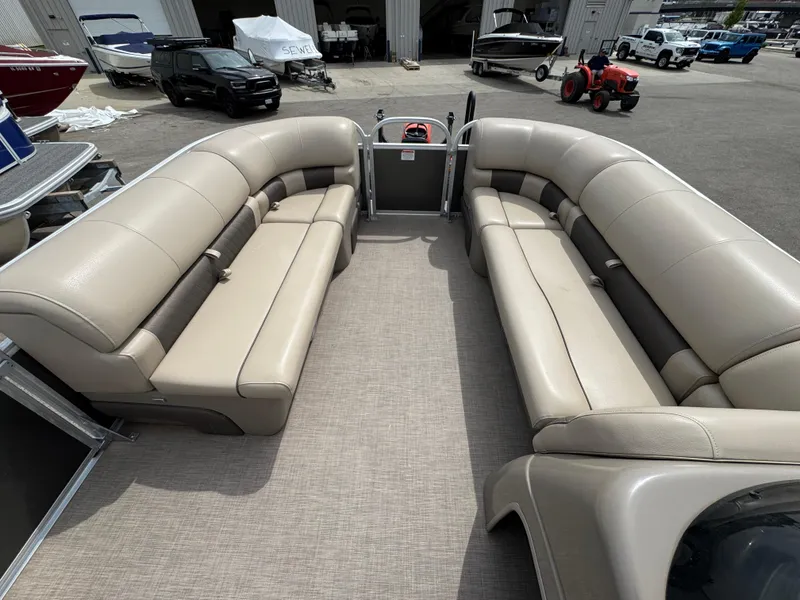 Slide: The Image of 2021 Sun Tracker Party Barge 20 DLX with spacious seating in a marina setting. - 13